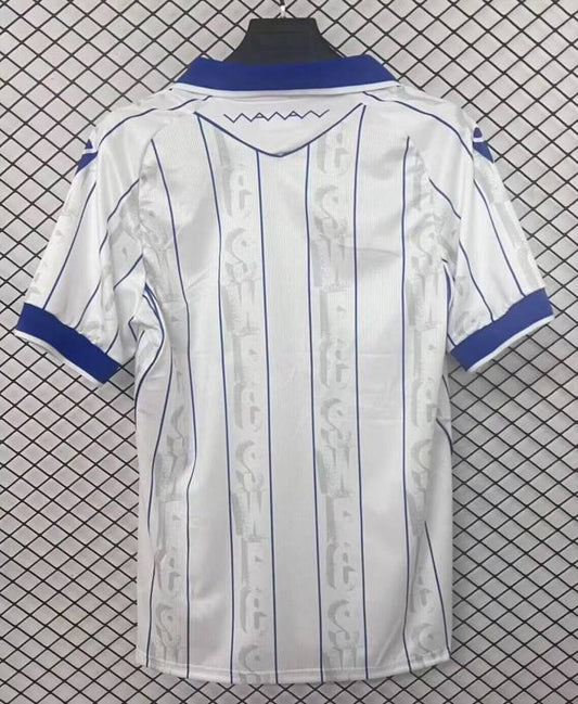 Camisola SHE-WED 2025-26 Alternativa Branca Versão Adepto