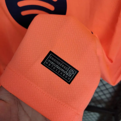 Camisola FC Barcelona 2025-26 Alternativa Laranja UCL Versão Adepto ROONY #19