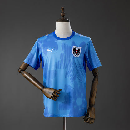 Camisola Austria 2026 Alternativa Azul Versão Adepto